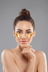Wall Mural - Woman With Under Eye Collagen Gold Pads, Beauty Model Girl Face With Healthy Fresh Skin. Skin Care Concept, Anti-Aging Moisturizing Eye Mask