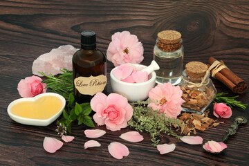 romantic love potion magic spell and aphrodisiac ingredients with herbs, rose flowers, honey, spring