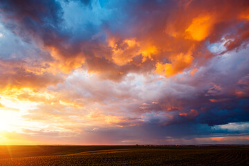 Sticker - An epic sunset with colorful clouds lit by the sun. Photo of textured sky.