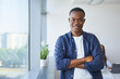 © baranq - Portrait of happy young businessman standing at office. Young man standing at startup office looking at camera