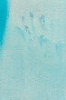 A fragment of a blue wall smudged with paint. Background or texture.