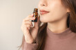 © KMPZZZ - Aromatherapy, attractive asian young woman hand holding bottle of essential perfume oil, enjoying smell fragrance of herbal from medicine natural organic at home. Therapy treatment, beauty skin care.