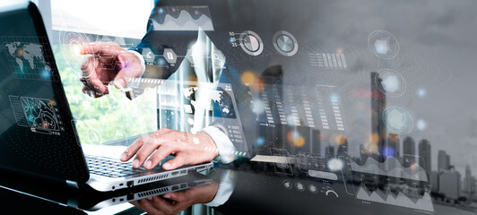 a guy programmer uses a laptop to evaluate and produce data on a future virtual interface screen. al