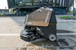 Automatic clean machine mopping outside of modern office building.