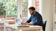 © insta_photos - Indian ethnic business man, busy eastern male professional, serious businessman computing remote learning or distance working online typing on laptop using computer sitting at home office table.