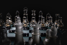 Chess Pieces On A Board Ready To Start A Game, On A Dark Background.