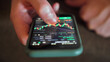 © metr1c - Hands with a mobile phone. Crypto trading in smartphone. close-up. Cryptocurrency trading.