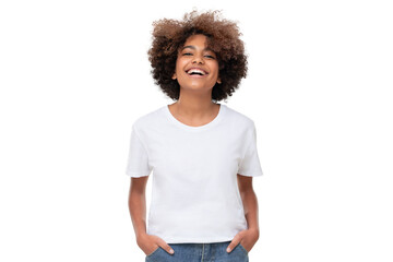 front view of laughing african teen girl standing with hands in pockets, wearing white tshirt with c
