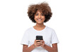 © Damir Khabirov - African american smiling teenage girl with afro hairstyle holding phone with both hands, chatting with friend, using social media app
