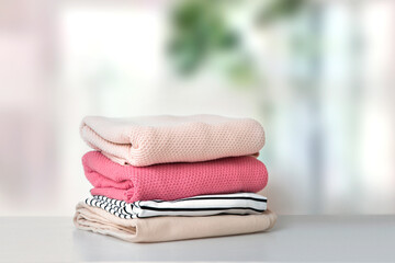 Wall Mural - Soft pink stacked knitted clothing.Stack of clothes.Laundry.