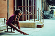© Carlos David - ballerina modern dancer outdoors sitting on a bench