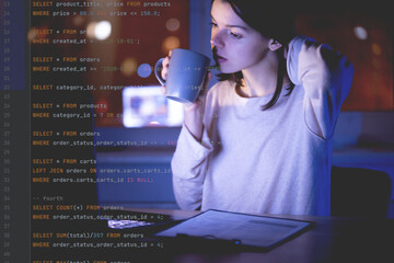 Girl works on a laptop at night, coding and creating project.