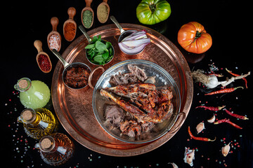 Wall Mural - Roasting head of a lamb. Traditional Turkish Offal Food Kelle Sogus, Lamb Head Meat with Brain Served Portion served on a copper plate.