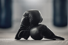 Boxing Gloves On The Floor Of A Gym After Exercise, Training And Workout. Pair Of Sport Handwear Or Equipment On The Ground After Fighting Match, Practice Or Punching In A Competitive Sports Club