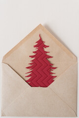 Poster - red holiday tree inside a brown envelope