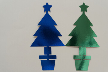 Poster - two metallic blue and green holiday trees standing side by side on blank paper