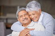 © Lumeez Ismail/peopleimages.com - Living room, love and senior couple hug on sofa for romantic embrace while they relax together in home. Care, trust and happiness in married relationship with partner in sweet marriage and commitment