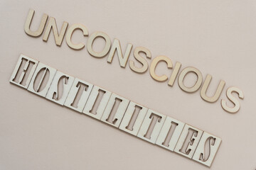 Wall Mural - unconscious hostilities - sign with wood type