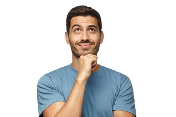 Young man in blue t-shirt with dreamy cheerful expression, thinking, looking up