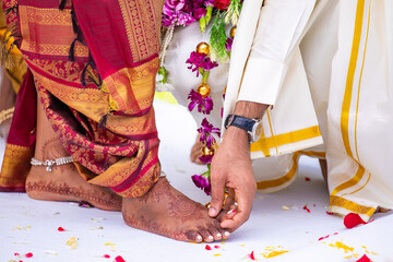 South Indian Tamil bride's feet ring exchange wedding ceremony close up
