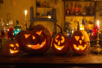 Wall Mural - Halloween pumpkins with candles and magic potions at night indoor