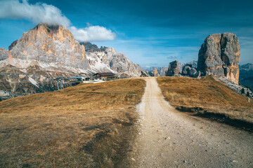 Mountain chalet and Cinque Torri rock formations in the Dolomites