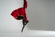 Flexible woman performs on the aerial silk on white background. Concept of originality, creativity and outstanding