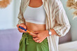 Young diabetic woman injecting insulin in her belly