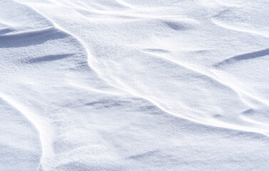 Wall Mural - Freshly fallen snow surface looking like dunes shaped by wind. Winter abstract snow texture background.