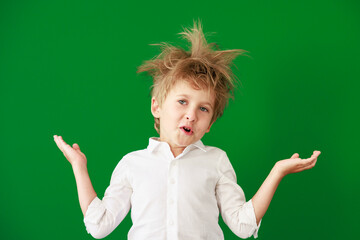 Poster - Surprised child against green chalkboard in class