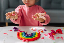 Child Hands Creating Rainbow From Play Dough For Modeling. Art Activity For Kids. Fine Motor Skills. Sensory Play For Toddlers.
