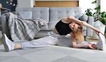 Woman Doing Stretching Exercise At Home.