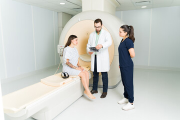 Wall Mural - Doctor and radiologist showing the MRI test results to a female patient