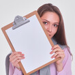 © shefkate - Woman showing a blank page of clipboard