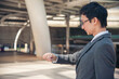 © aFotostock - Asian businessman wear suit, eye glasses standing street in modern city. Portrait Young handsome asian man look at bright future smart, confident. Entrepreneur executive man cityscape outside office