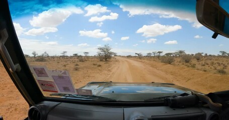 Wall Mural - A 4x4 drives through the savannah in Kenya