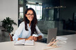 © Velista production - Attractive business lady in glasses working in nice office and looking at camera and smiling.