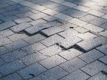 Uneven Sidewalk Tiles. Potholes, Insecurity And Risk