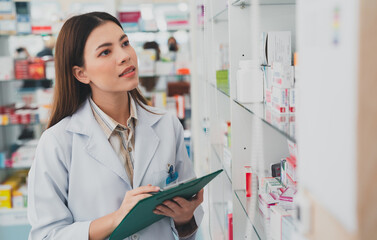 female pharmacist at drugstore.Doctors specializing in medicines.Medical product inventory.female doctor holding a prescription.Health care pharmacists work at the hospital.