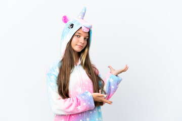 Poster - Little caucasian girl wearing unicorn pajama isolated on white background extending hands to the side for inviting to come