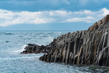 Rocky Seashore Formed By Columnar Basalt Against The Surf, Coastal Landscape Of Kunashir Island