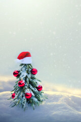 Wall Mural - christmas tree with red santa hat on white snow.