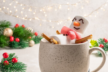 Mug with hot chocolate with melted marshmallow snowman. Merry Christmas drink. Happy Holiday card