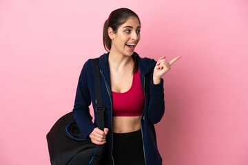 Wall Mural - Young sport caucasian woman with sport bag isolated on pink background intending to realizes the solution while lifting a finger up