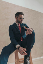 Attractive Young Man In Suit Looking To Side And Posing In A Cool Manner