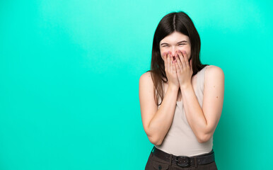 Wall Mural - Young Russian woman isolated on green background happy and smiling covering mouth with hands