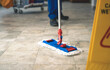 Mop on the flor.A worker mops the flor with the mop.Cleaning concep