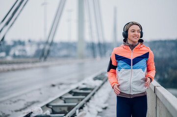 Wall Mural - Woman running on the bridge at winter and snow.