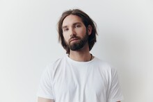 Portrait Of A Man With A Black Thick Beard And Long Hair In A White T-shirt On A White Isolated Background Lifestyle Without Pathos Everyday Image