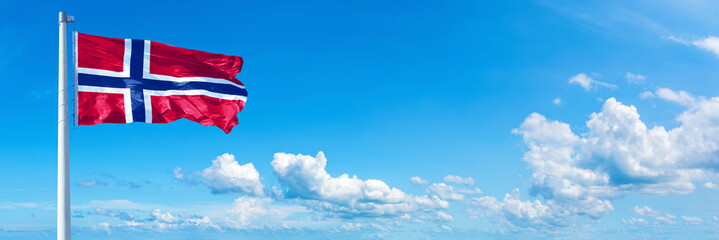 Wall Mural - Norway flag on a blue sky *** Horizontal banner 12000 x 4000 px